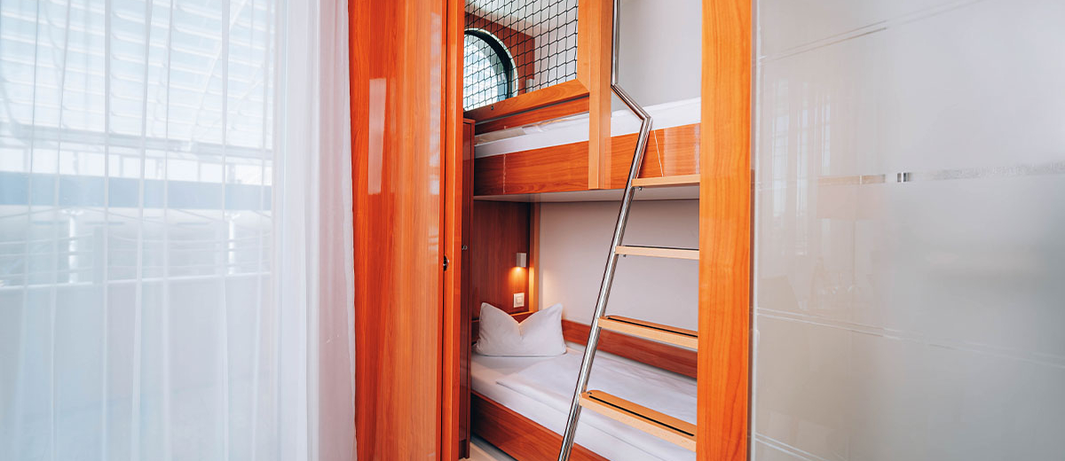 Panorama-Außenkabine Kinder Doppelstockbett Hotel Victory Therme Erding Stilvolles Doppelzimmer im Hotel Victory Therme Erding mit Holzverkleidung, TV, Sitzecke und offenem Bad – gemütlich übernachten