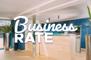Text on picture: Business Rate. Hotel reception in the background with large plant and bright furnishings